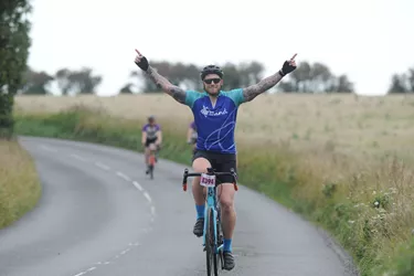 Happy female cyclist taking part in a road event
