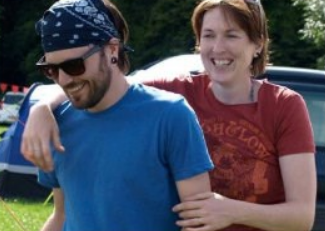 Photo of Kate and her partner relaxed and smiling