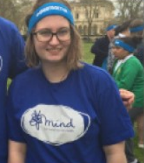 woman with glasses smiling wearing Mind shirt