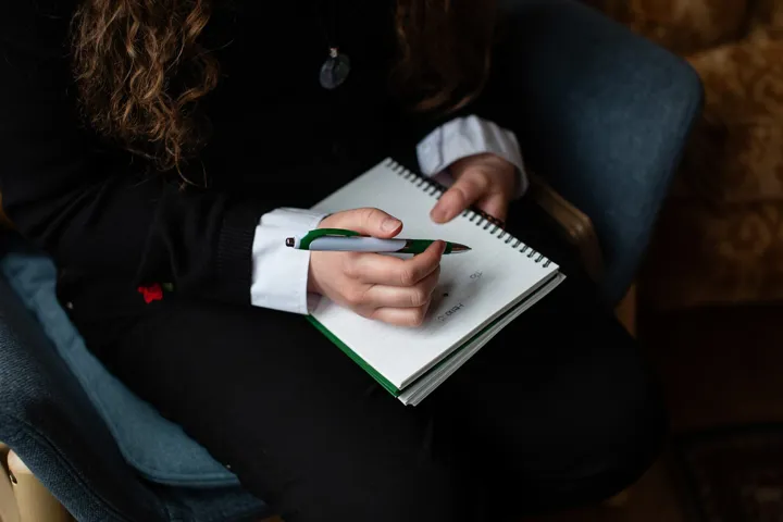 Close Up Of Person Writing In Note Pad Close Up Of Person Writing In Note Pad