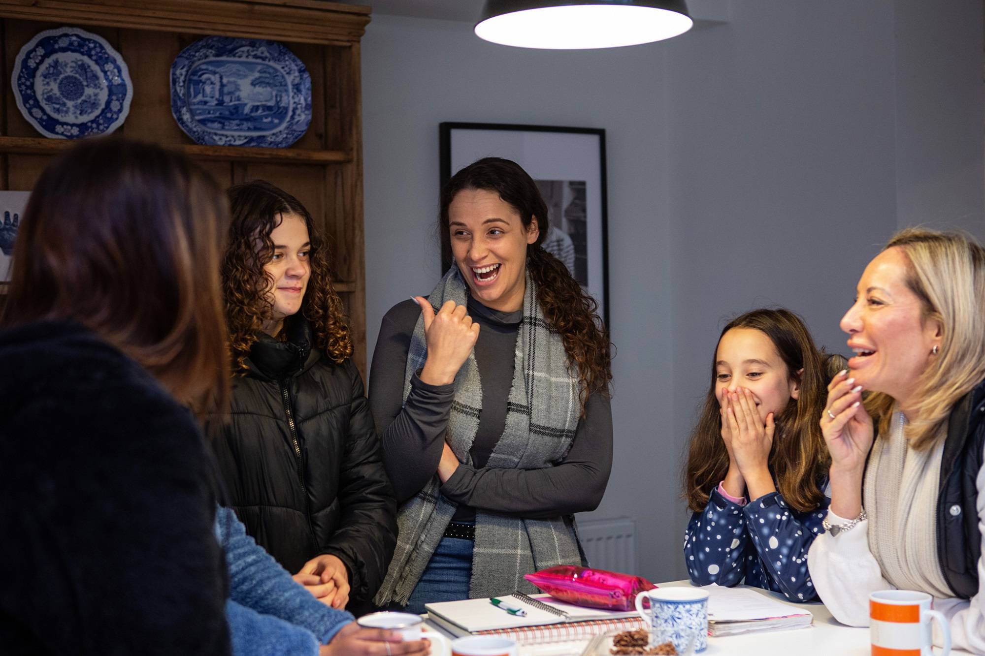 Group Of Women And Young Teen Girls Chatting And Laughing