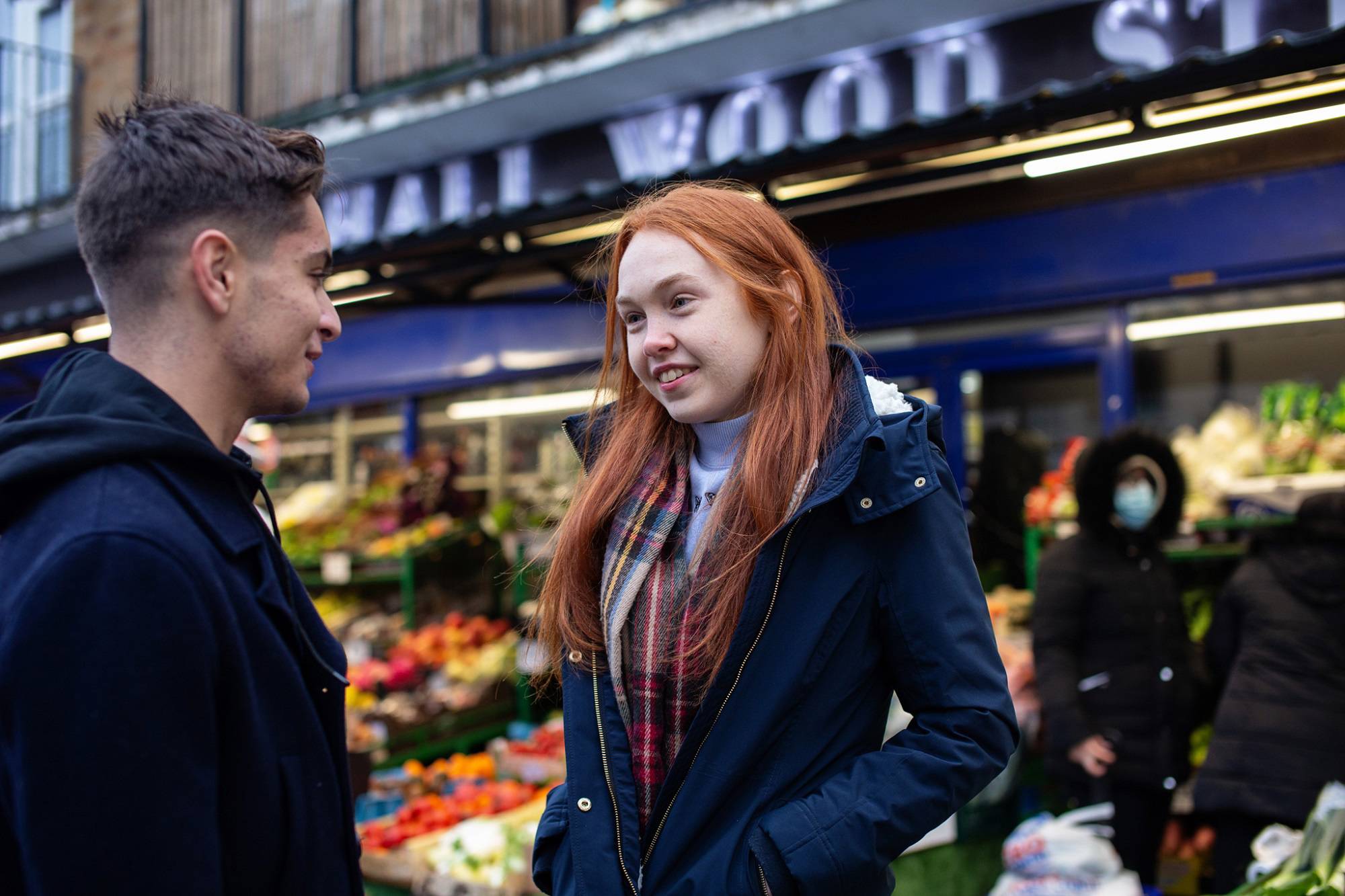Teen Boy And Teen Girl Chatting Outside Shop