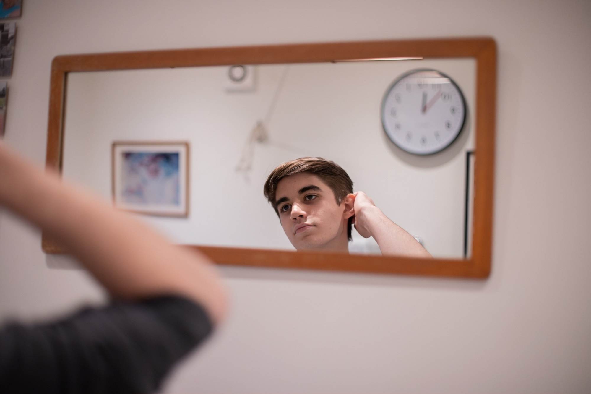 Teen Boy Doing Hair In Mirror