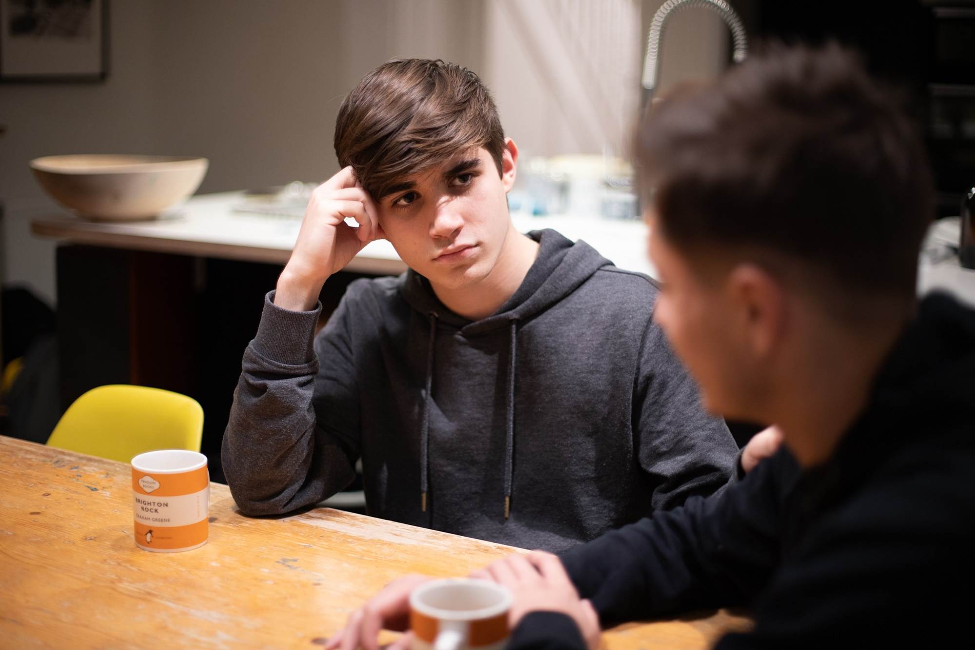 Teen Boy Listening To Other Teen Boy Supportively Looking Serious