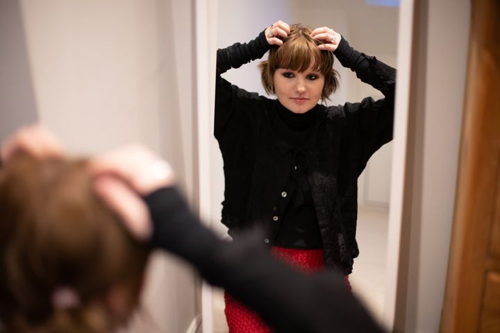 Teen Girl Doing Hair In Mirror