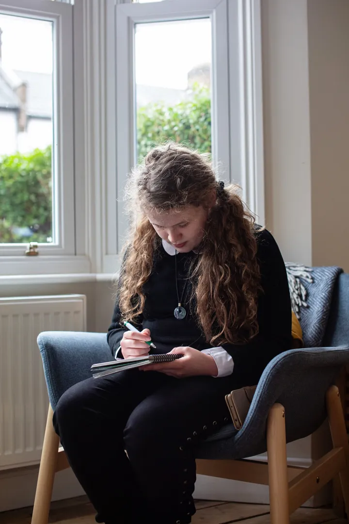 Teen Girl Sits Writing Close Up Teen Girl Sits Writing Close Up