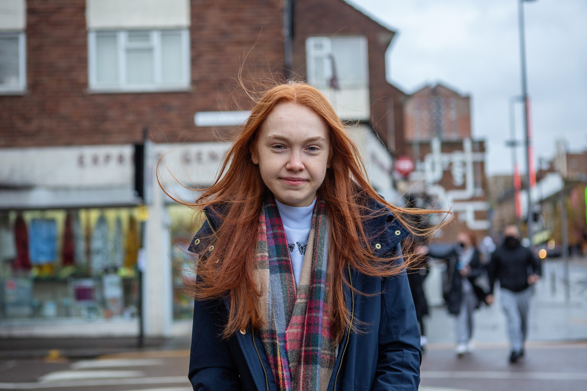 Teen Girl Stands In Town Centre Smiling