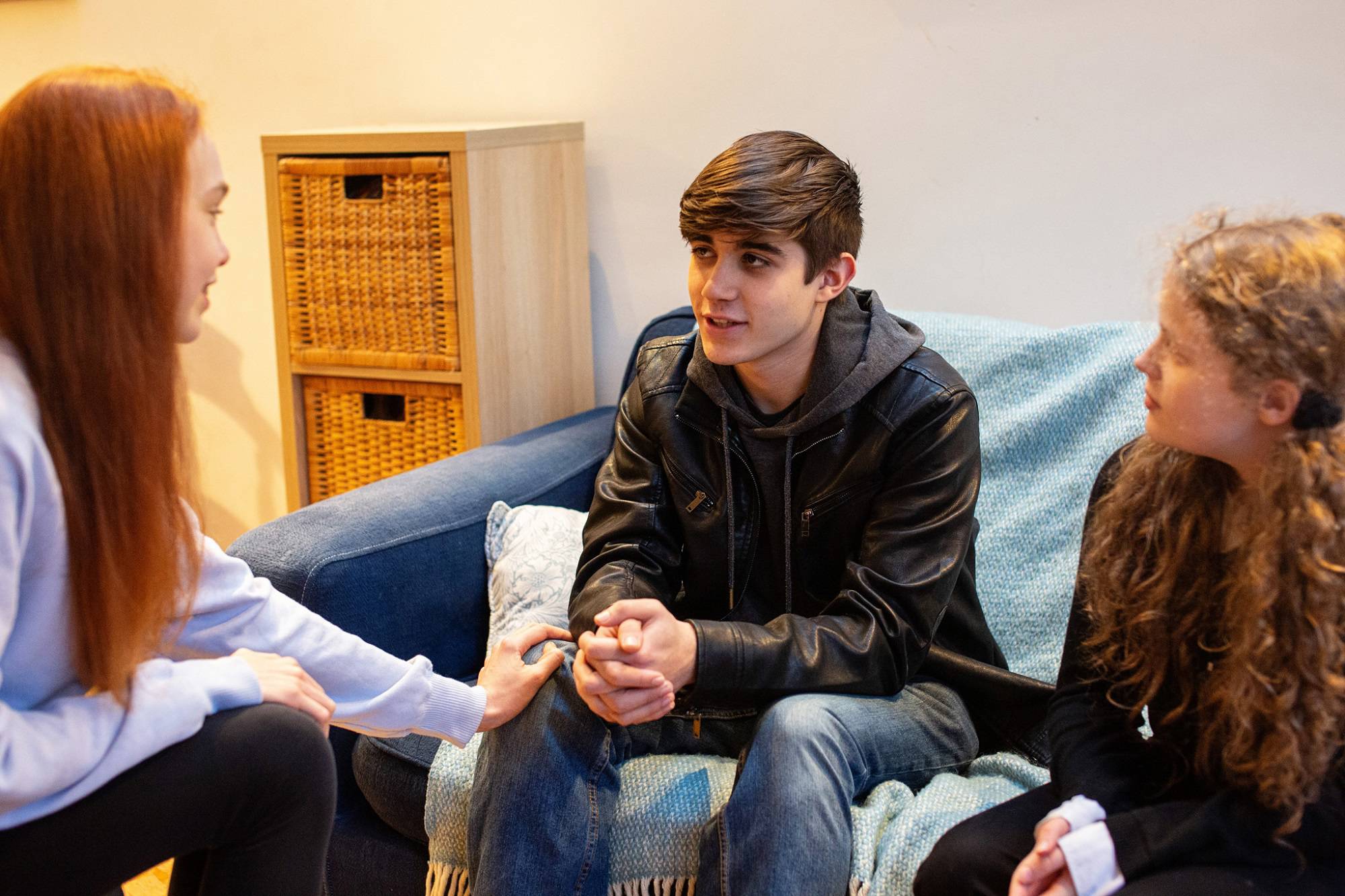 Teen Girl With Hand On Teen Boys Knee Being Supportive