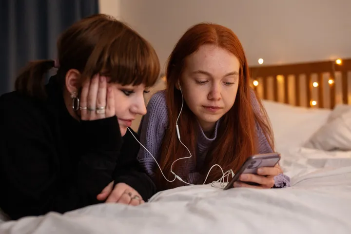 Teen Girls Sharing Music On Phone Neutral Expression Teen Girls Sharing Music On Phone Neutral Expression
