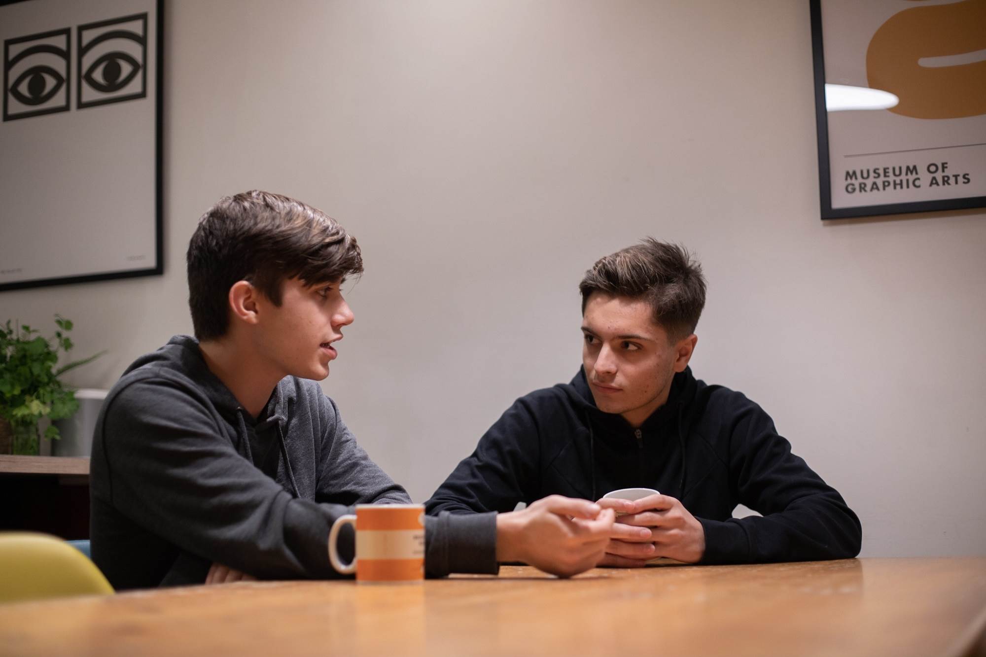 Two Teen Boys Having A Serious Chat At The Table