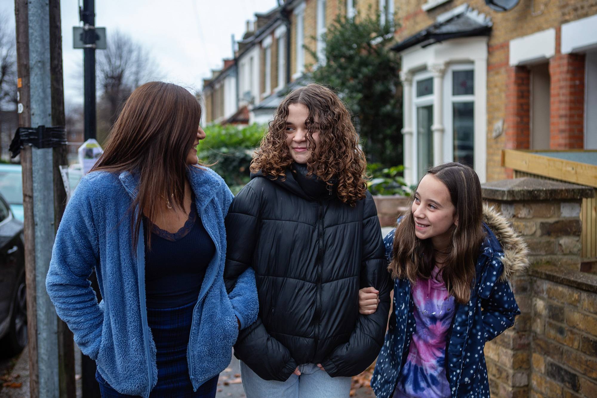 Woman Teen Girl And Young Girl Walking Down The Street Smiling