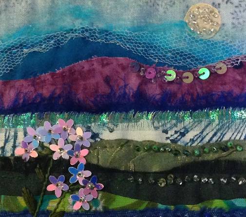 Jan McCarthy's artwork, of layers of different textured materials which create an image of a field, skyline and horizon.