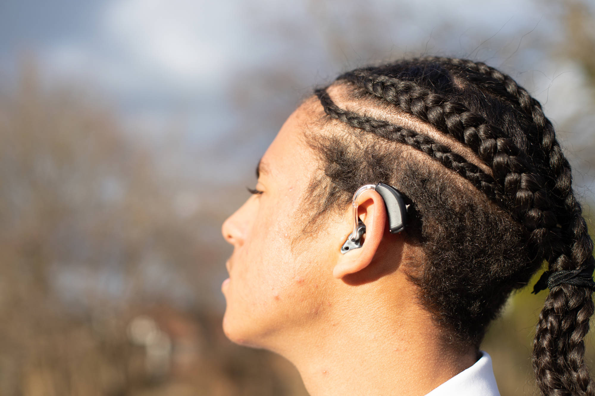 Young Person Side Profile Look Away From The Camera With Hearing Aid