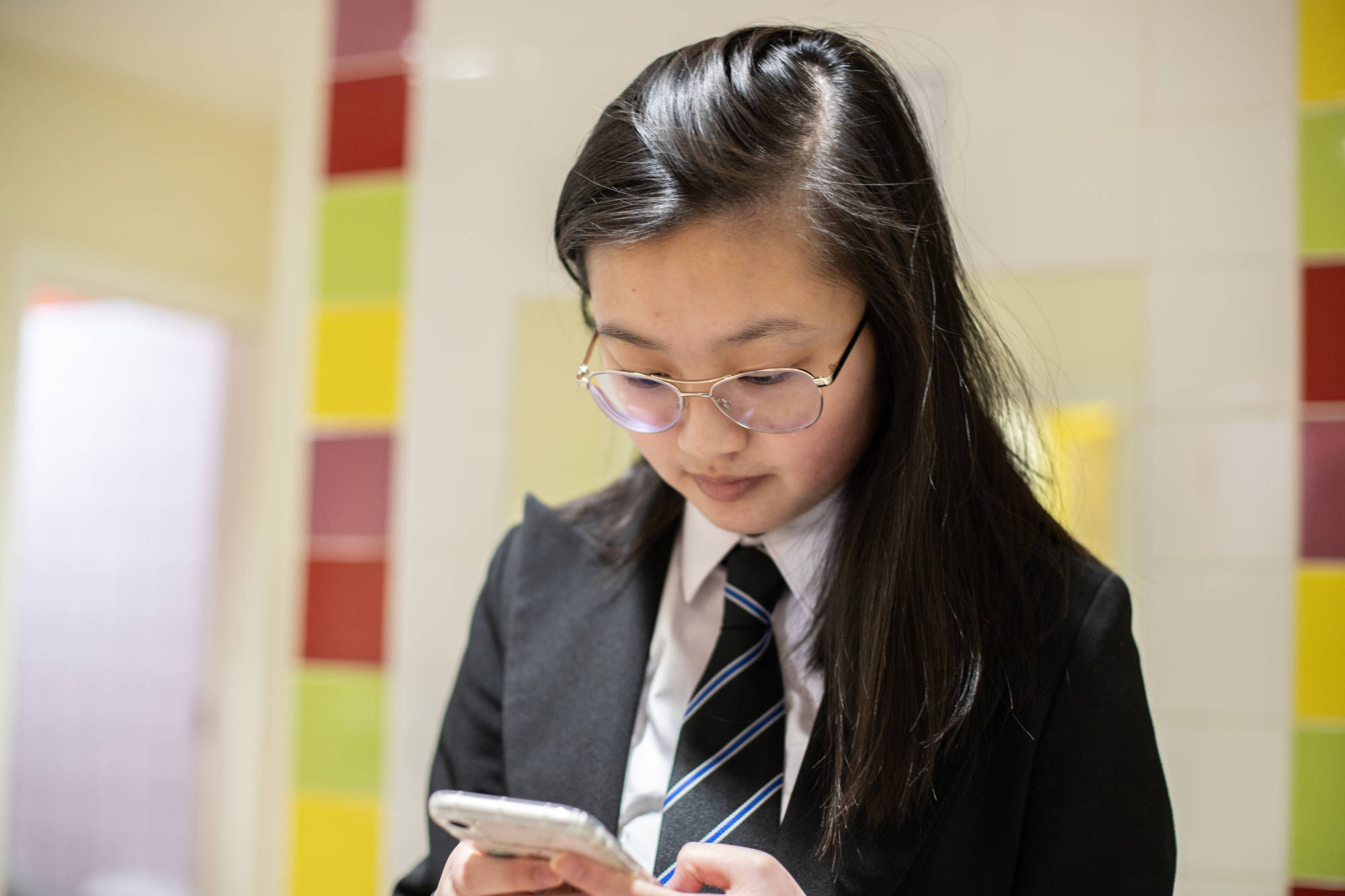 Student Texting in school bathroom