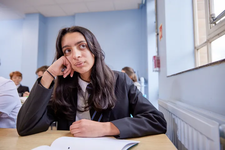Student Thinking At Desk