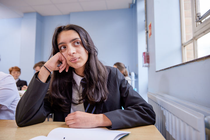 Student Thinking At Desk