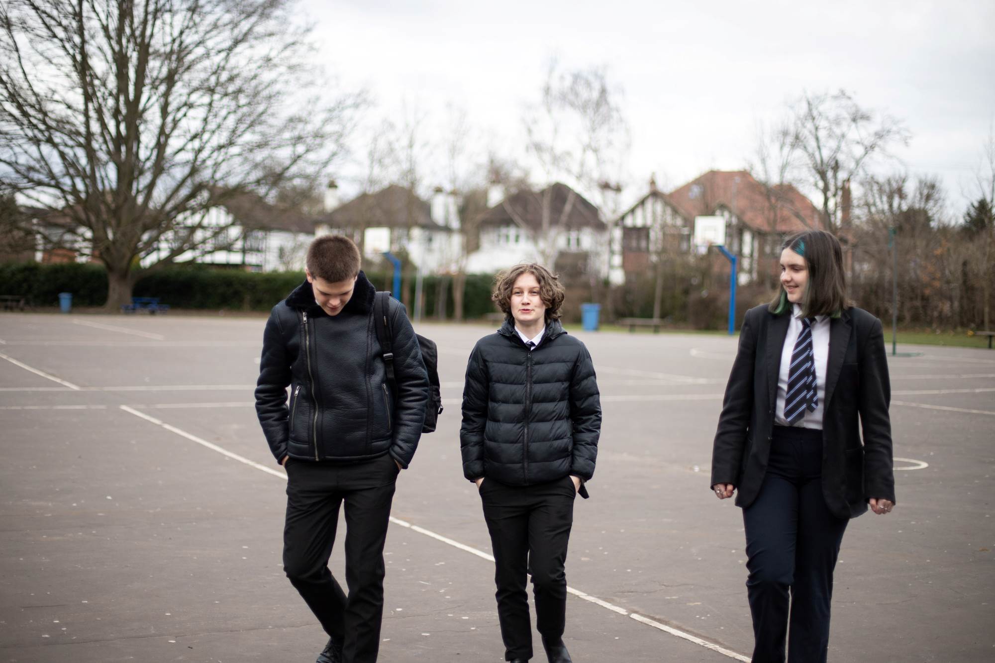 Three Young People Walking Through School
