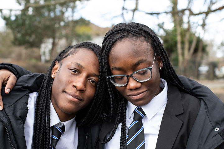 Two Young People Arms Around One Another