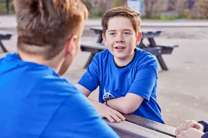 Young People Chatting At A Picnic Table Young People Chatting At A Picnic Table