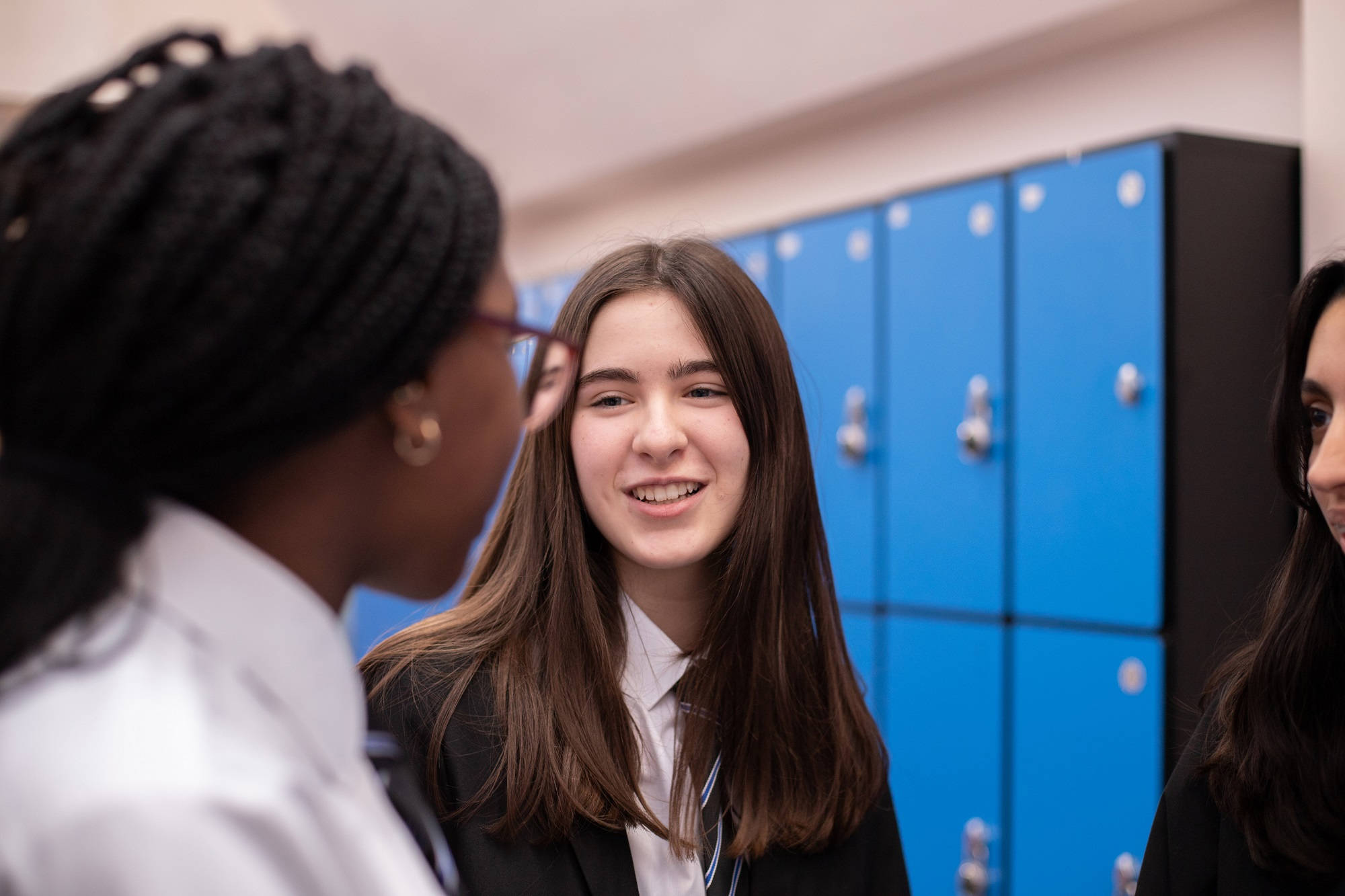 Young People Chatting In Front Of Lockers