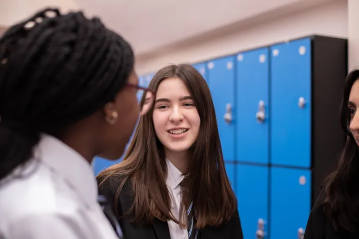 Young People Chatting In Front Of Lockers Young People Chatting In Front Of Lockers