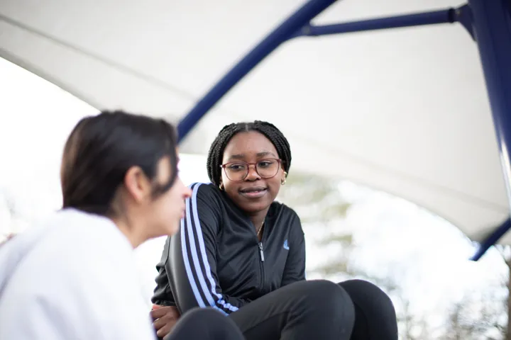 Young People Chatting In Playground Young People Chatting In Playground