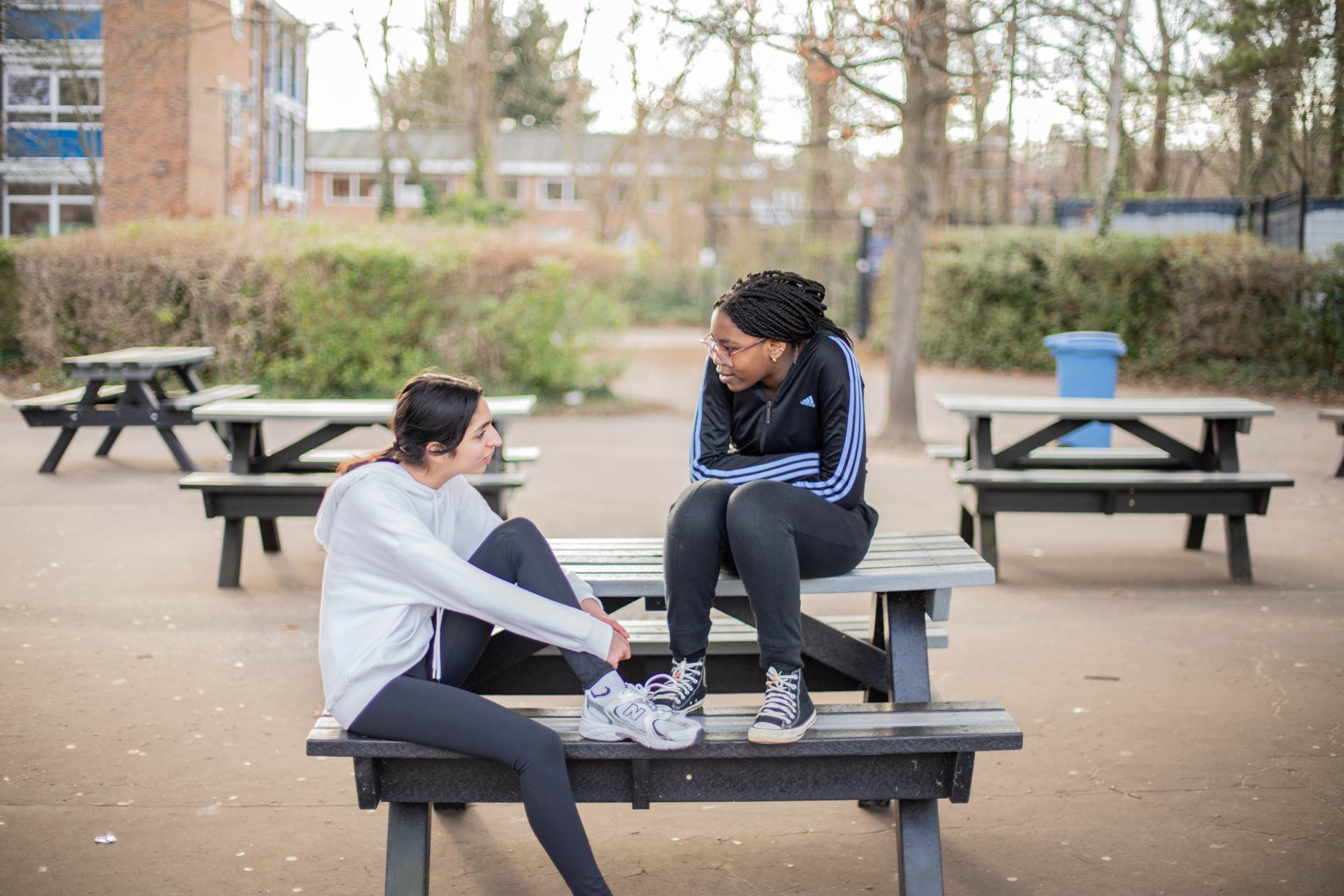  Young People Chatting On Picnic Benches