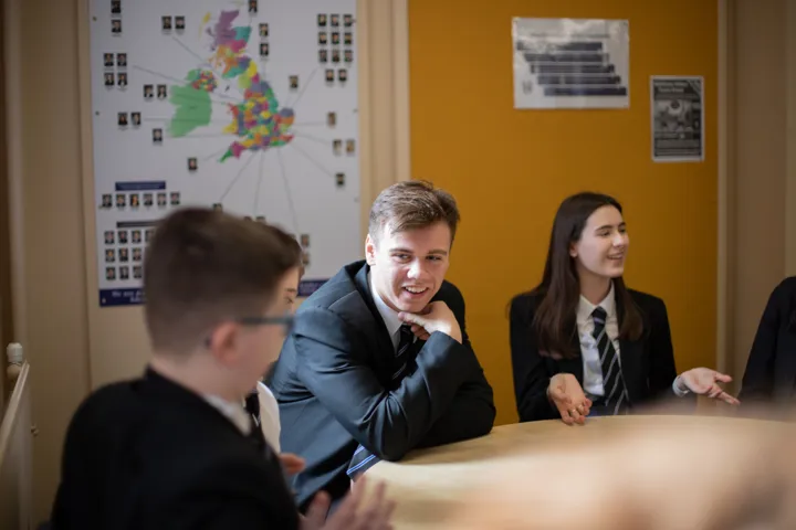 Young People Discussing In Classroom Setting Young People Discussing In Classroom Setting