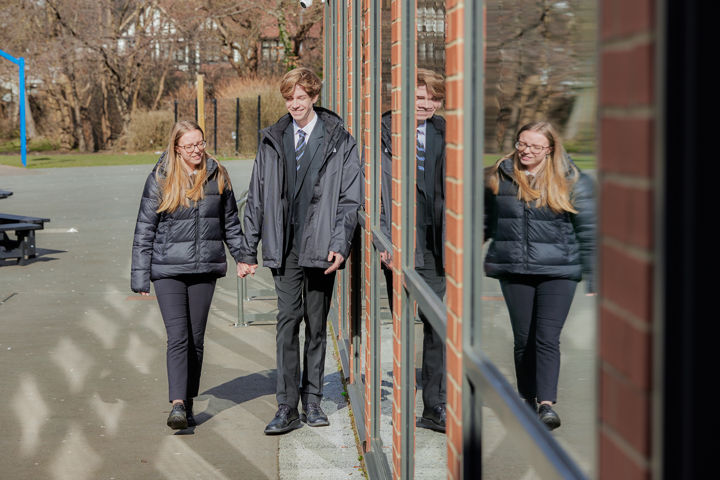 Young People Holding Hands Outside School Walking