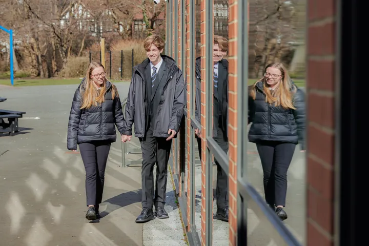 Young People Holding Hands Outside School Walking Young People Holding Hands Outside School Walking