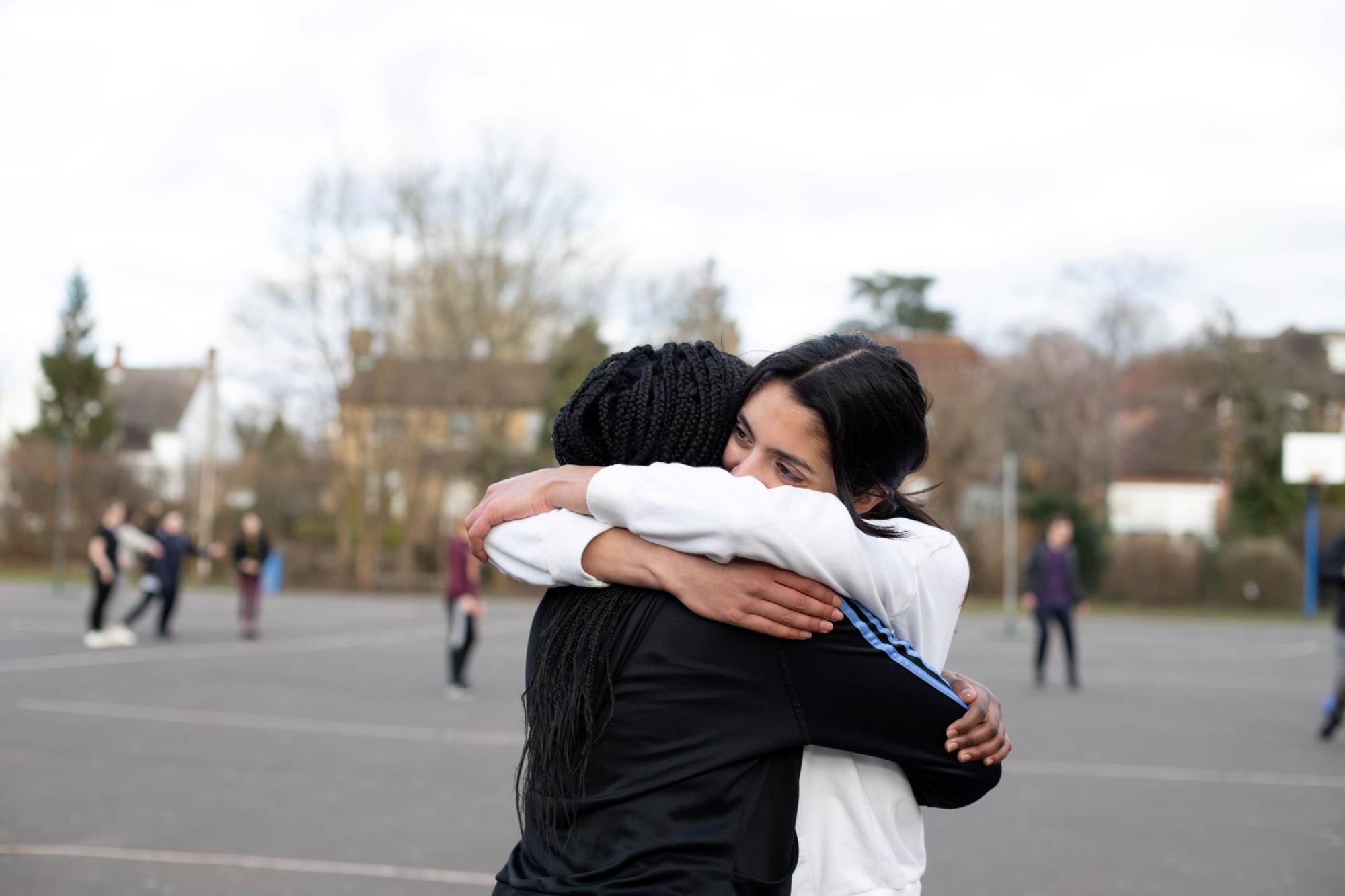 Young People Hugging In Playground