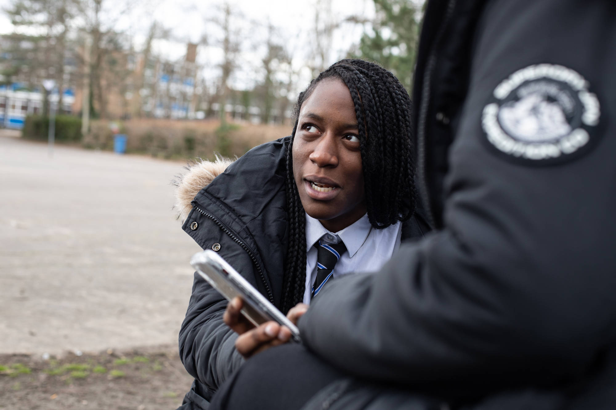 Young People Sharing Information On Phone