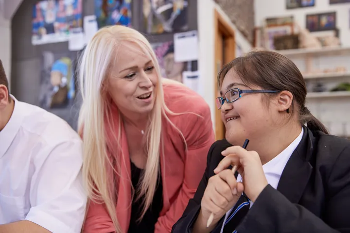 Young Person And Teacher Chatting In Classroom Young Person And Teacher Chatting In Classroom
