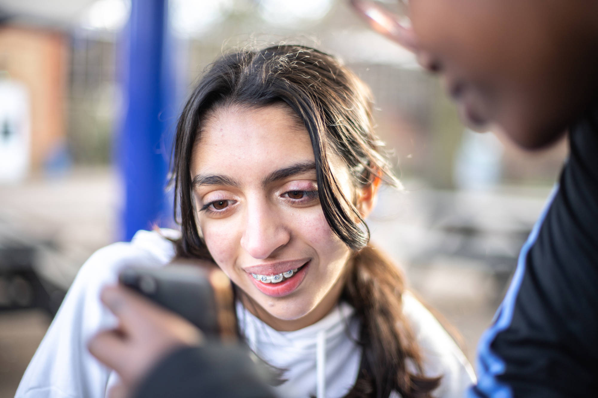 Young Person At Looking Another Phone