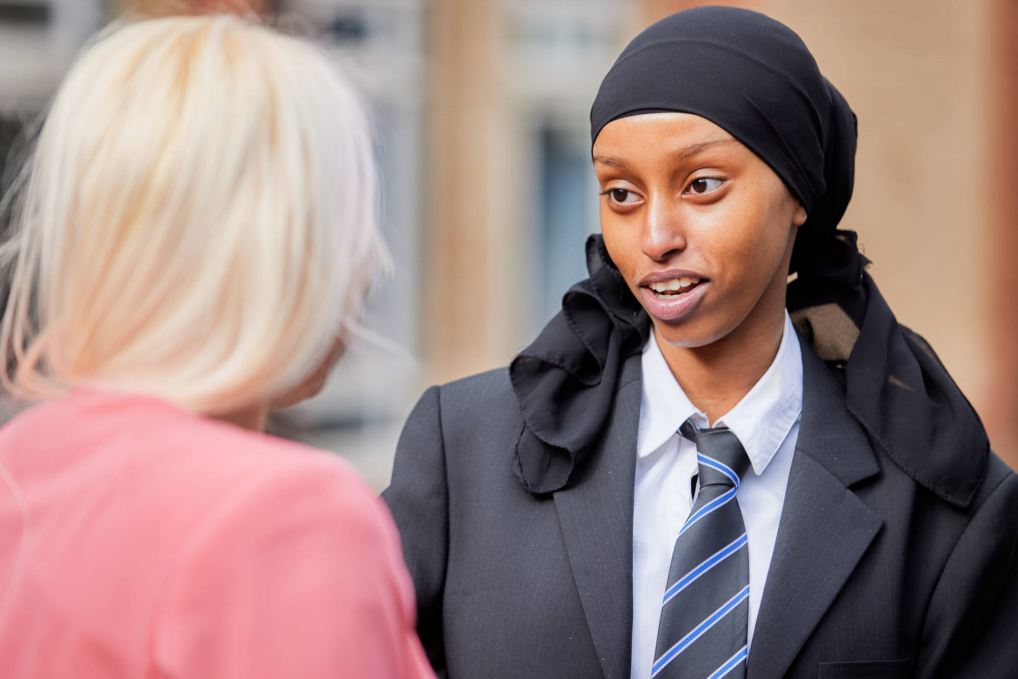Young Person Chatting To Teacher Close Up