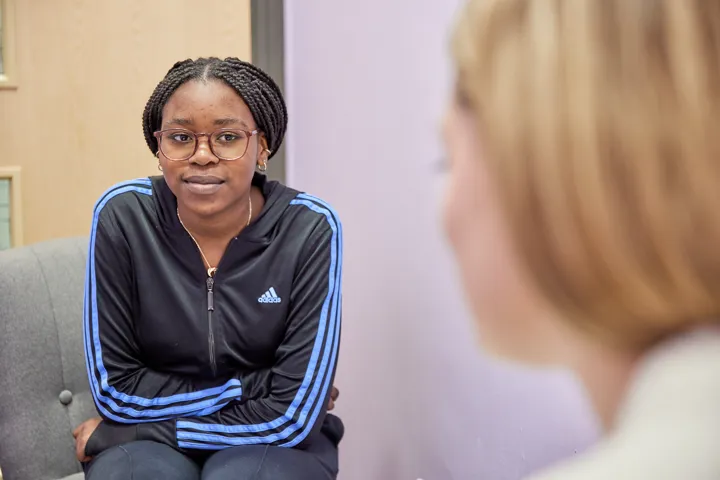 Young Person Chatting To Teacher Closeup
