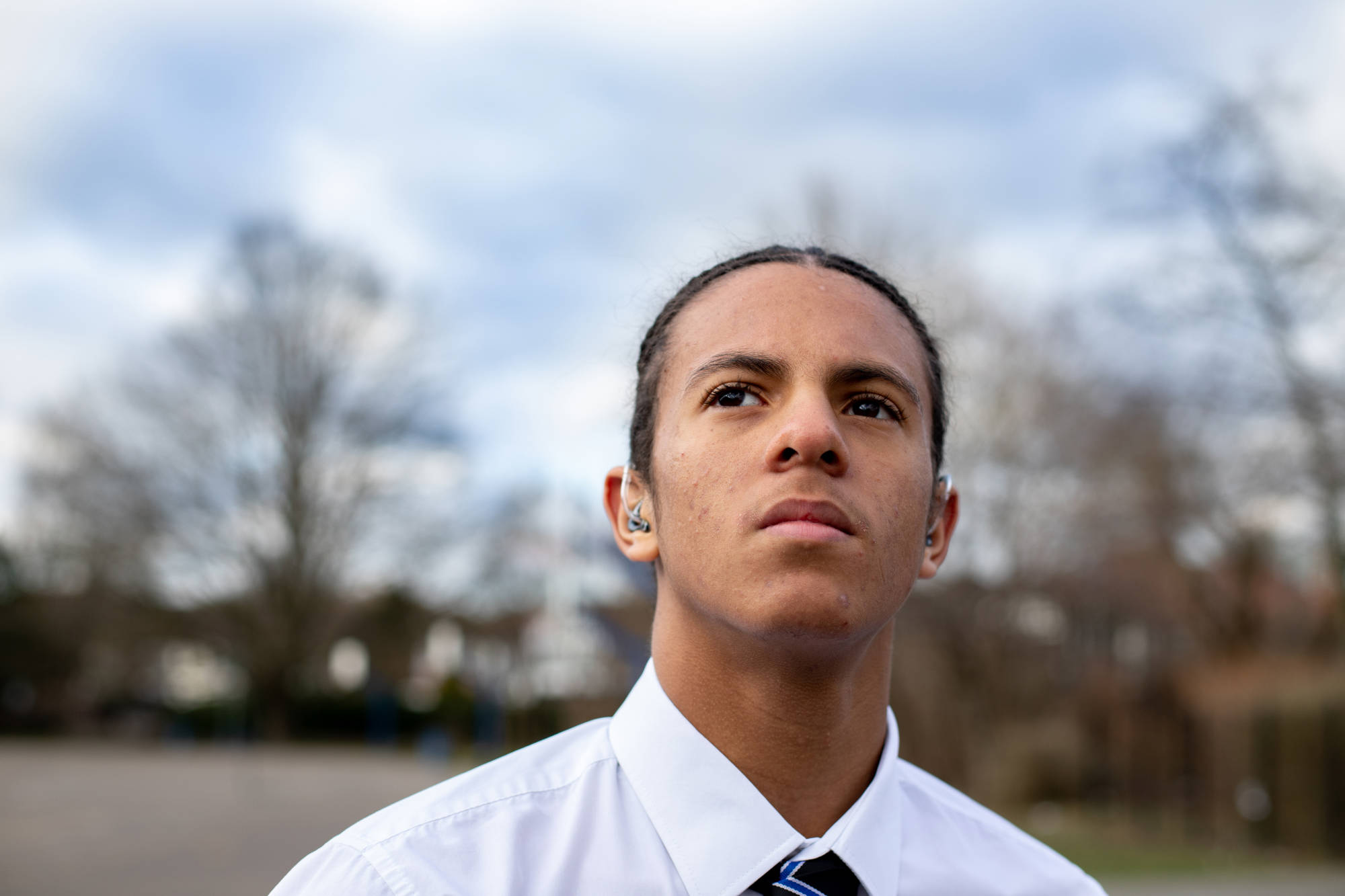 Young Man Smiling Away From Camera