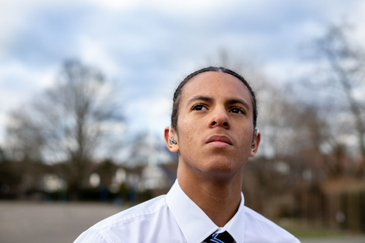 Young Person Close Up Looking Past The Camera