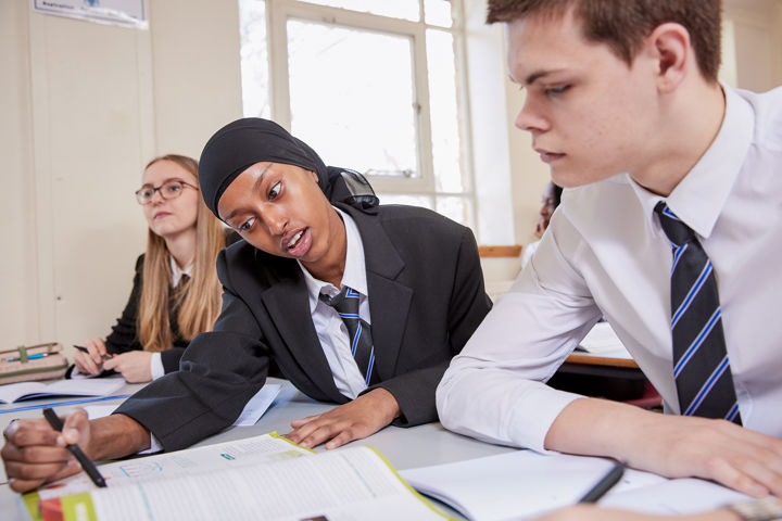 Young Person Helping Someone In Class