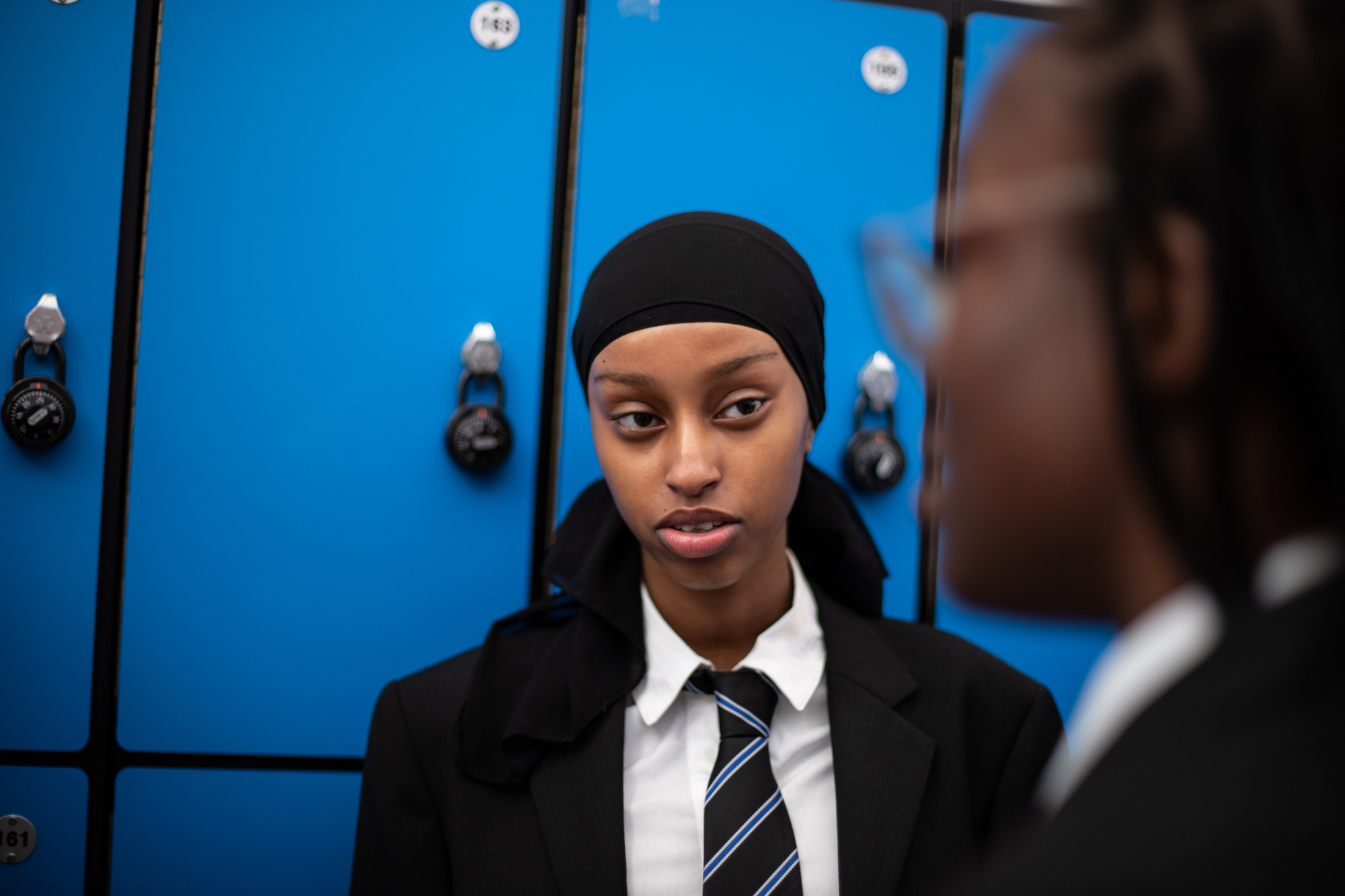Young Person Looking At Camera In Front Of Locker