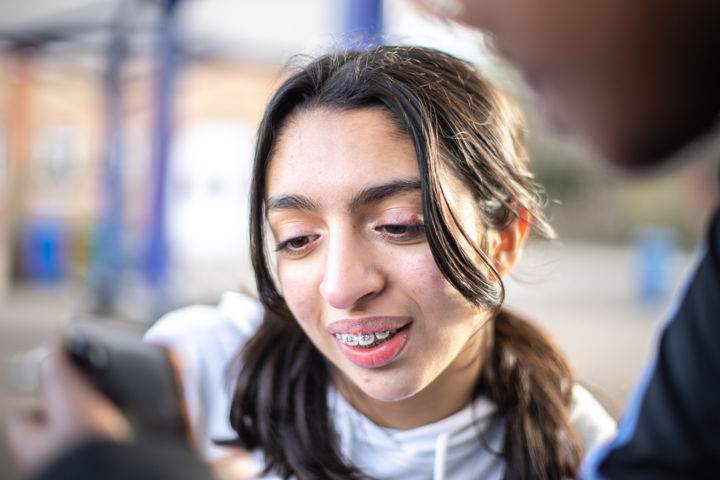 Young Person Looking At Phone
