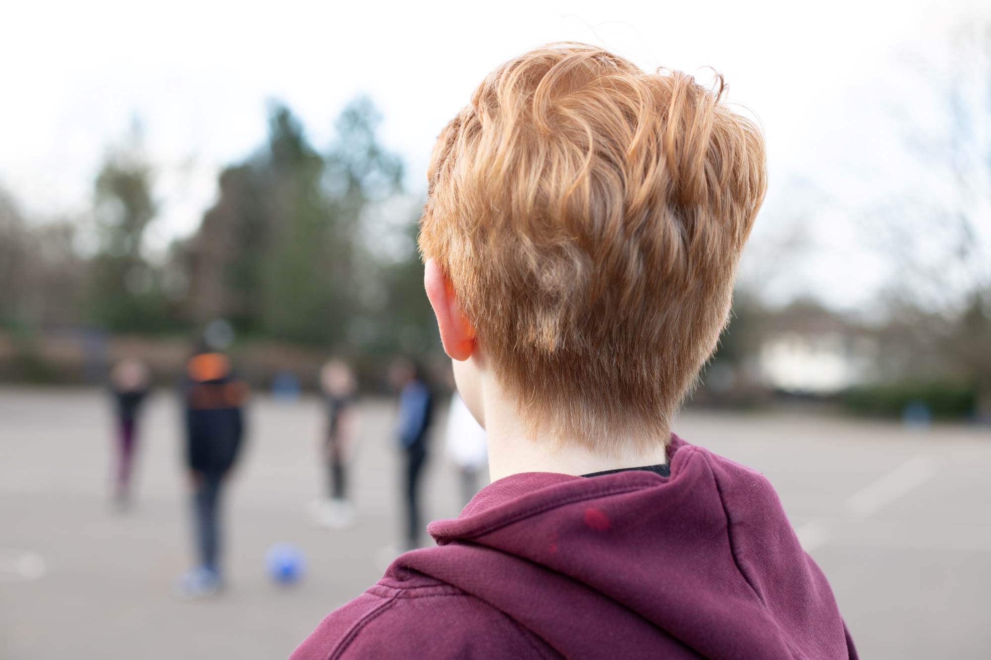 Young Person Looking Out Onto Playground