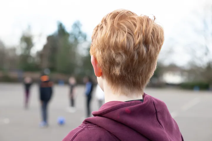 Young Person Looking Out Onto Playground Young Person Looking Out Onto Playground