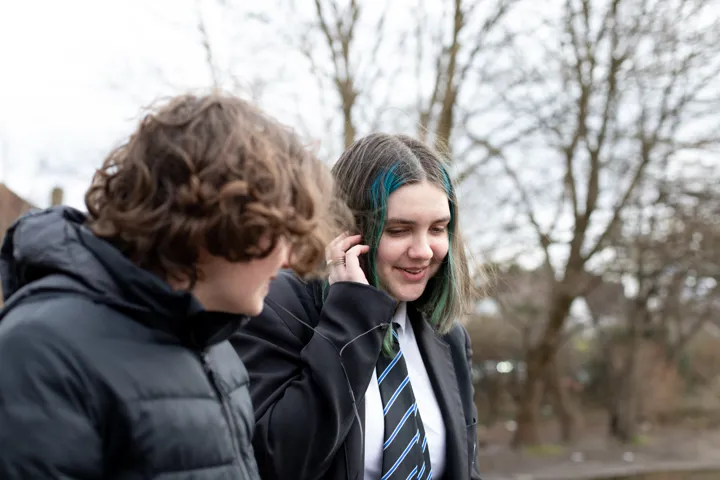 Young Person On The Phone Walking