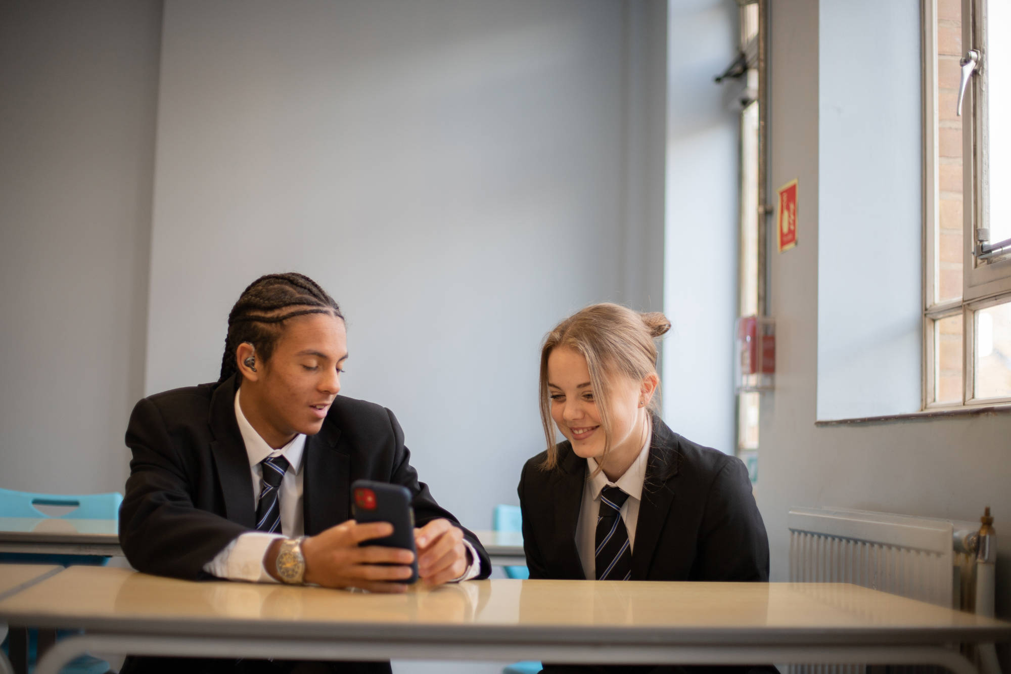Young Person Sharing Texts At A Desk