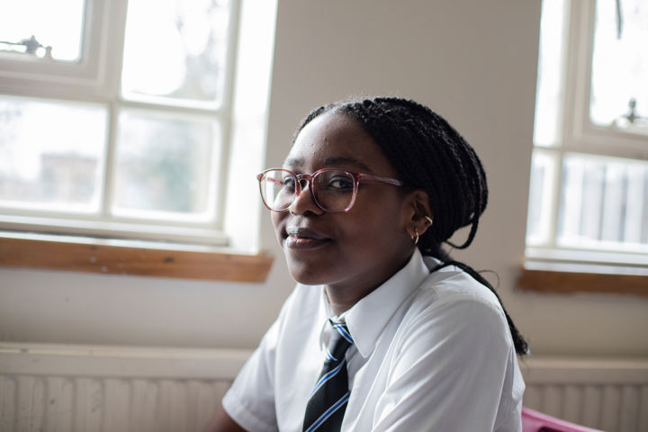 Young Person Sitting In Chair Chatting To Teacher