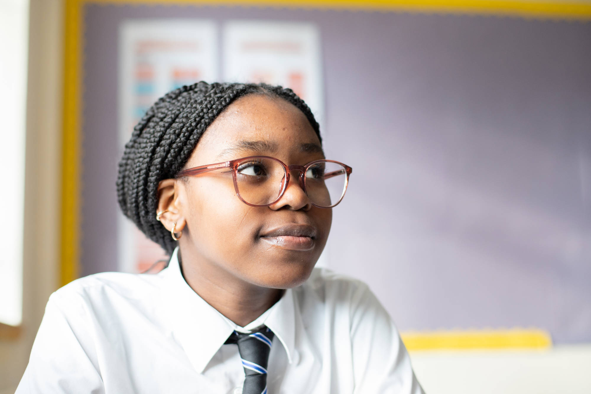 Young Person Smiling In Classroom At The Camera