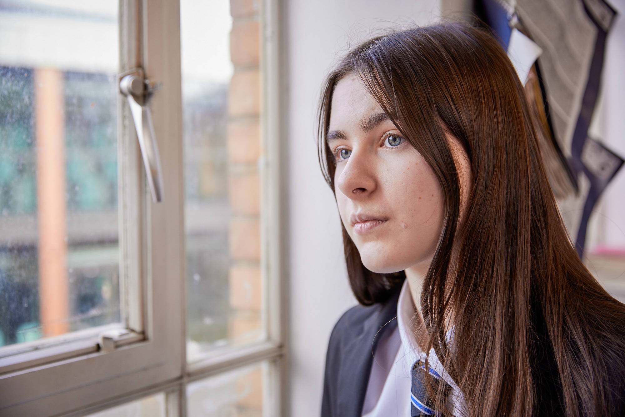 Young Person Staring Past The Camera