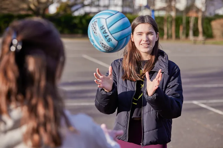 Young Person Throwing Up Ball In Playground Young Person Throwing Up Ball In Playground