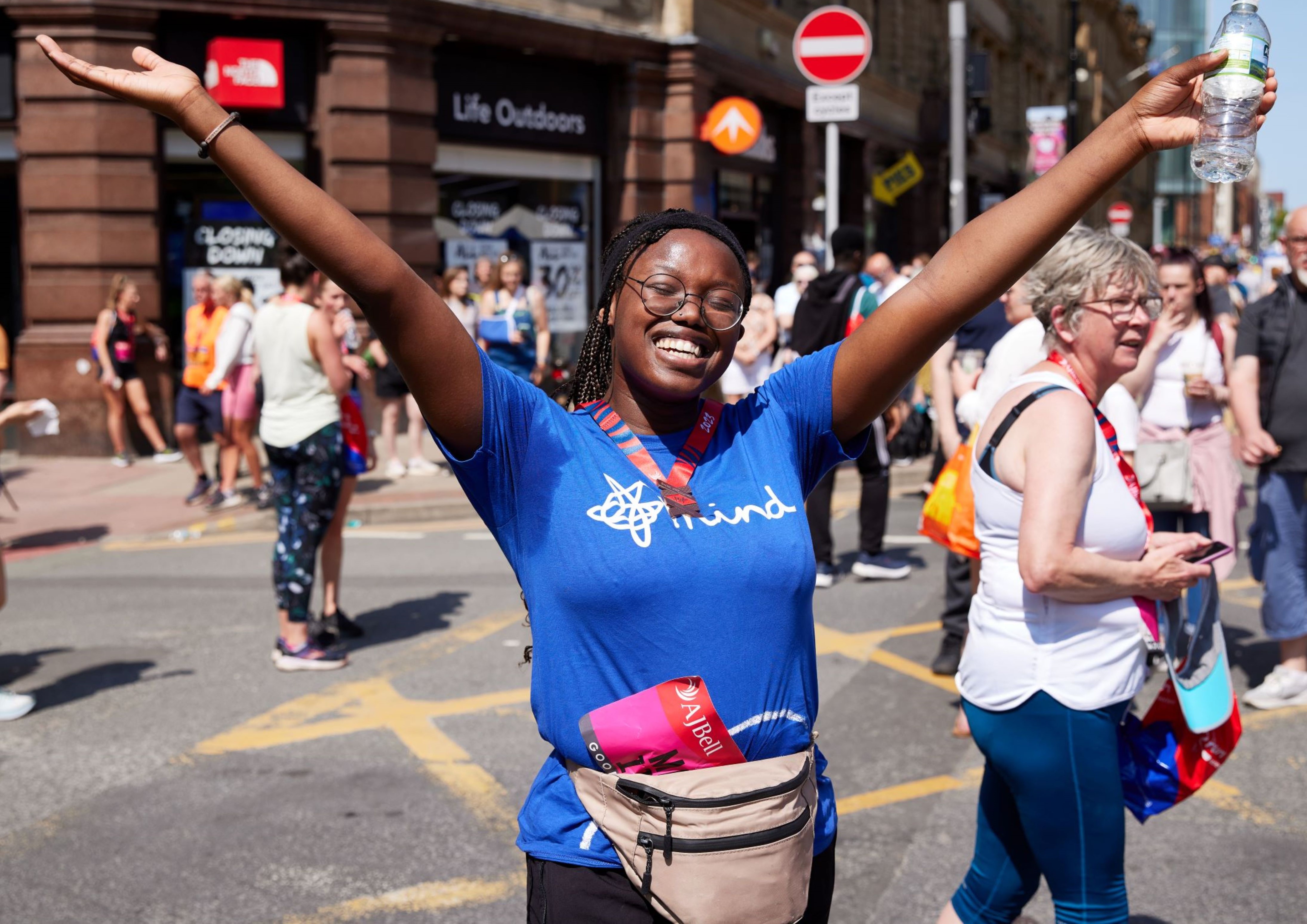 Smiling Mind runner with hands in the air